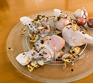 A plate of raw chicken drumsticks