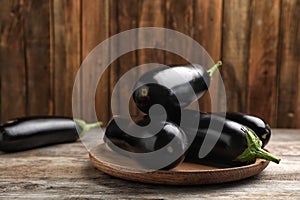Plate with raw ripe eggplants