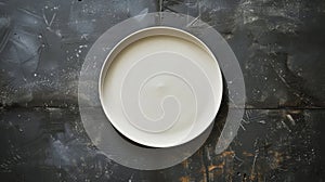 A plate on a black table with fork and knife