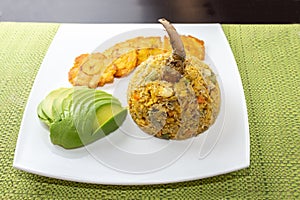 Plate of rice with crab with avocado and fried green banana