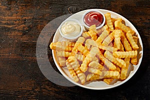 Plate of rippled french fries with copy space