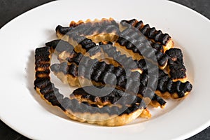 Plate of ruined and burned french fries