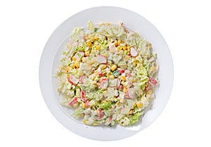 plate of salad with crab sticks, corn and vegetables isolated on white background