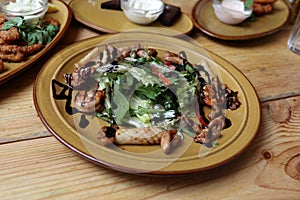 Plate of salad with quid on the table