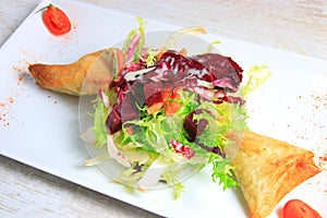 Plate of samoussa and lettuce salad