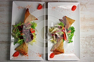 Plate of samoussa and lettuce salad