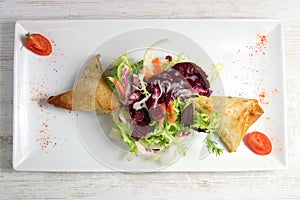 Plate of samoussa and lettuce salad