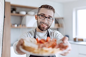 Plate of sandwiches in the hands of an attractive man