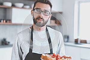Plate of sandwiches in the hands of an attractive man