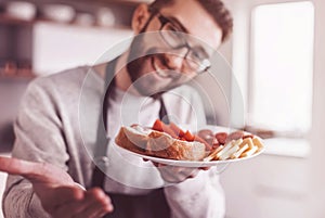 Plate of sandwiches in the hands of an attractive man