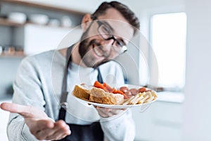 Plate of sandwiches in the hands of an attractive man