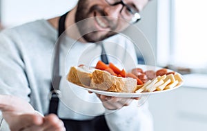 Plate of sandwiches in the hands of an attractive man