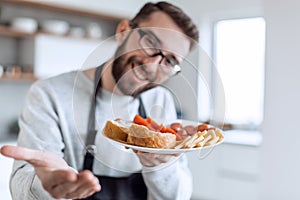 Plate of sandwiches in the hands of an attractive man