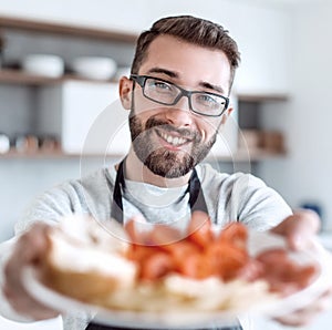 Plate of sandwiches in the hands of an attractive man