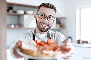 Plate of sandwiches in the hands of an attractive man