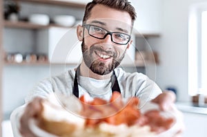 Plate of sandwiches in the hands of an attractive man