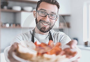 Plate of sandwiches in the hands of an attractive man