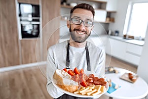 Plate of sandwiches in the hands of an attractive man