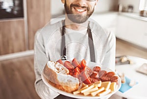 Plate of sandwiches in the hands of an attractive man