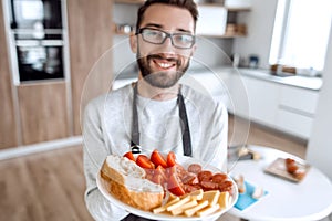 Plate of sandwiches in the hands of an attractive man