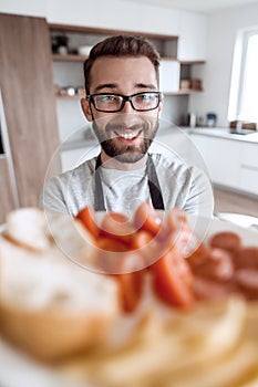 Plate of sandwiches in the hands of an attractive man