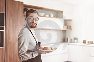 plate of sandwiches in the hands of an attractive man