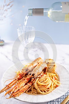 A plate with seafood for the festive table. Pasta with Norwegian lobster and white wine. Food for gourmets. Free space