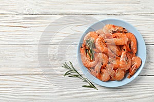 Plate with shrimps on background, top view photo