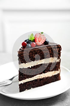 Plate with slice of chocolate sponge berry cake