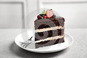 Plate with slice of chocolate sponge berry cake