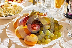 Plate with sliced fruits on servered buffet table at wedding restaurant. Catering banquet table in restaurant. Restaurant