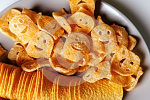 The plate of smiley face potato chips and ridged potato chips