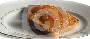 jam on rusks on white plate on the table