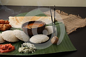 Plate of south indian food idli sambar dosa wada chutney,
