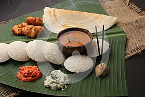 Plate of south indian food idli sambar dosa wada chutney,