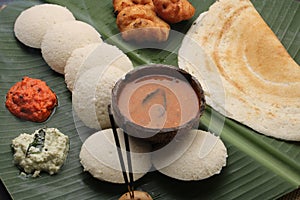 Plate of south indian food idli sambar dosa wada chutney,