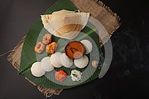 Plate of south indian food idli sambar dosa wada chutney,