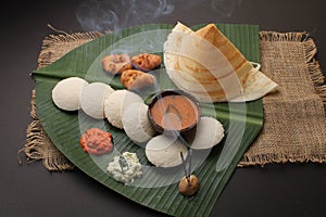 Plate of south indian food idli sambar dosa wada chutney,