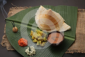 Plate of south indian food idli sambar dosa wada chutney,