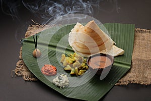 Plate of south indian food idli sambar dosa wada chutney,