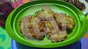 a plate of Southeast Asian food corncakes called perkedel jagung