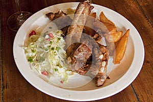 Plate with spare ribs with lettuce and fried potato
