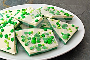 Plate of St Patricks Day candy bark with shamrock sprinkles