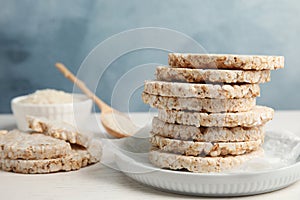 Plate with stack of crunchy rice cakes on table.