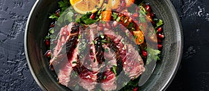 Plate of Steak, Oranges, and Pomegranates