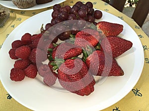 Plate of strawberries, raspberries and grapes