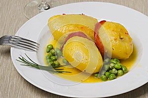 Plate with stuffed potatoes with peas. photo