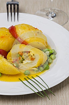Plate with stuffed potatoes with peas. photo