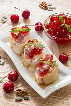 A plate of sugared cherry fruits sandwiches.