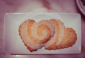 Plate with sweet baking for Valentines day. Shortbread cookies in shape of heart